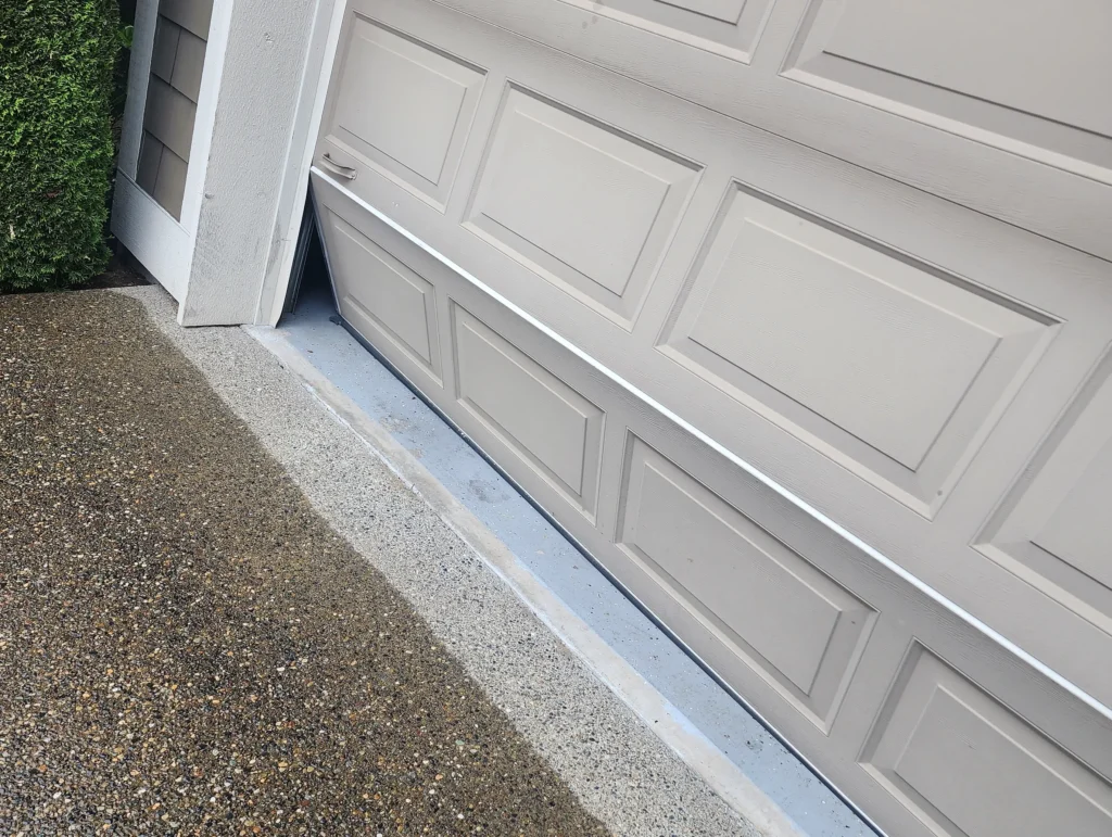 Garage door misaligned at the bottom.