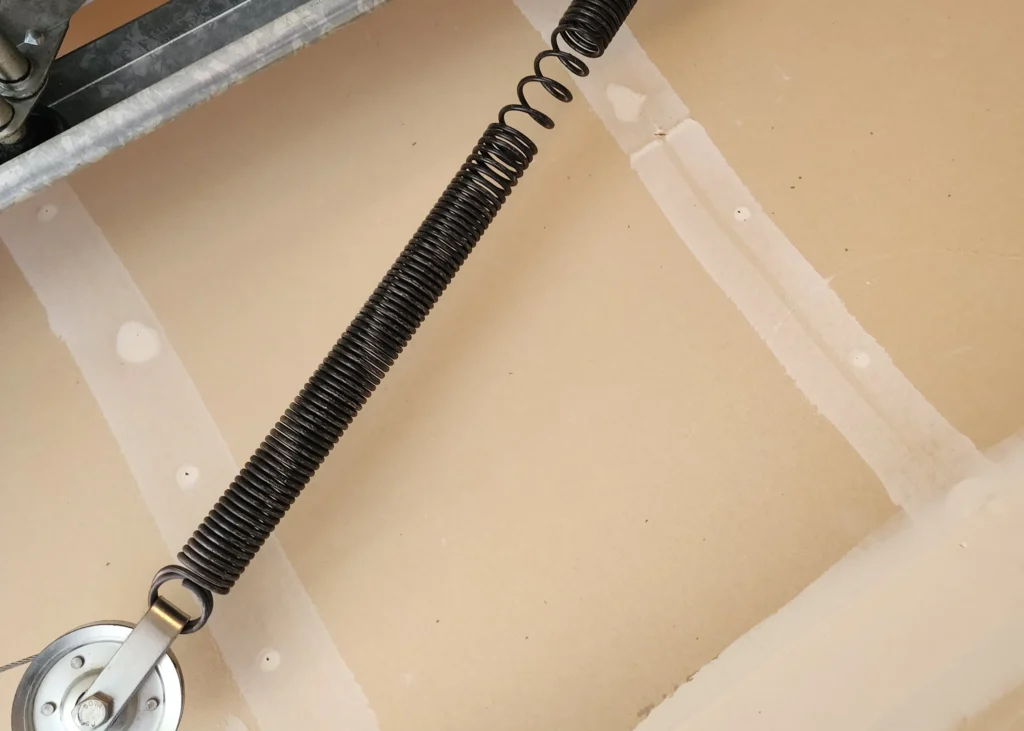 Coiled spring attached to pulley system