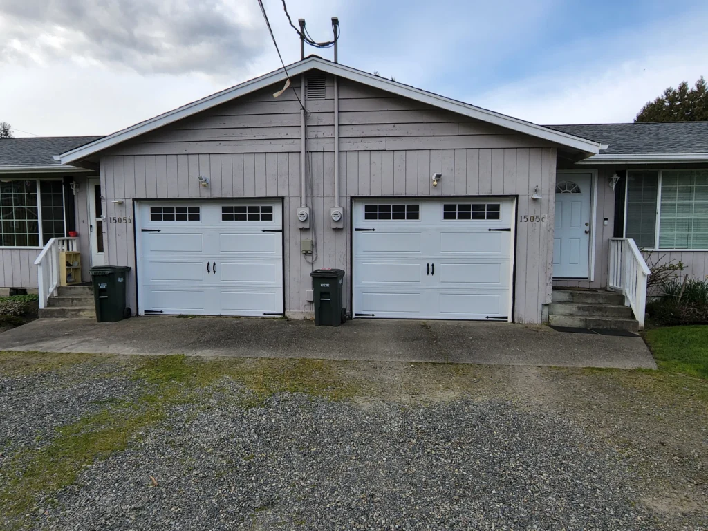 Residential duplex with garage doors